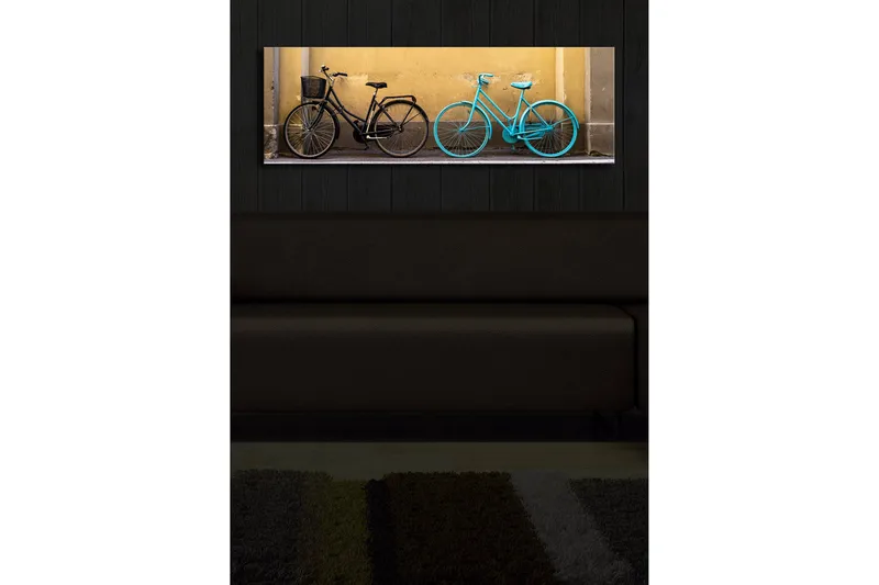 Lerretsbilde med LED-belysning 30x90 cm - Sykler i kontrastfarger mot en gul vegg - Svart / Turkis / Gul - Interiør - Maleri & posters - Lerretsbilder