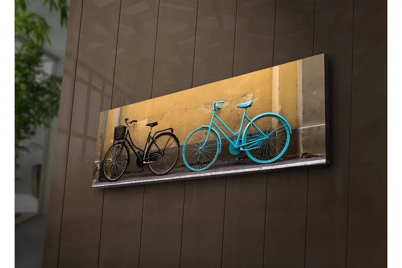 Lerretsbilde med LED-belysning 30x90 cm - Sykler i kontrastfarger mot en gul vegg - Svart / Turkis / Gul - Interiør - Maleri & posters - Lerretsbilder