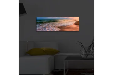 Lerretsbilde med LED-belysning 30x90 cm - Vakker strand med solnedgang og myke bølger - Blå / Oransje / Beige - Interiør - Maleri & posters - Lerretsbilder