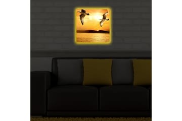 Lerretsbilde med LED-belysning 40x40 cm - Fugler som flyr over en solnedgang ved havet - Gull / Oransje / Svart - Interiør - Maleri & posters - Lerretsbilder
