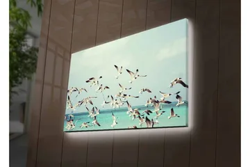 Lerretsbilde med LED-belysning - Flok med fugler som flyr over en blå havoverflate - Lyseblå / Hvit / Svart - Interiør - Maleri & posters - Lerretsbilder