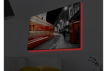 Lerretsbilde med LED-belysning - Rød buss i bevegelse på en svart-hvit bygate - Rød / Svart / Grå - Interiør - Maleri & posters - Lerretsbilder
