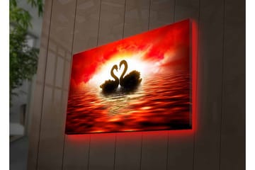 Lerretsbilde med LED-belysning - To svaner som danner et hjerte mot en dramatisk solnedgang - Rød / Svart / Oransje - Interiør - Maleri & posters - Lerretsbilder