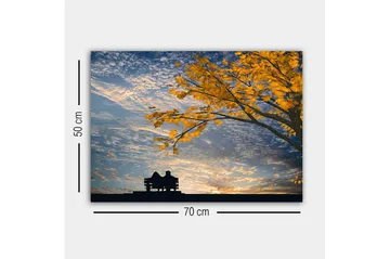 Lerretsbilde - Silhuett av et par som sitter på en benk under et tre med gyldne høstblader - Gull / Blå / Svart - Interiør - Maleri & posters - Lerretsbilder