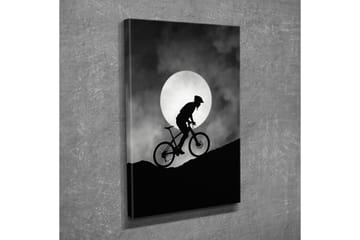 Lerretsbilde - Syklist som klatrer opp en bakke under en stor måne - Svart / Grå - Interiør - Maleri & posters - Lerretsbilder