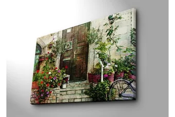 Stort lerretsbilde 100x70 cm - Vakker dør omgitt av fargerike blomster og grøntområder - Rød / Grønn / Lilla - Interiør - Maleri & posters - Lerretsbilder